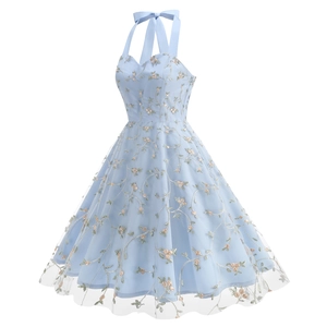 Close-up of light blue mesh dress featuring delicate floral embroidery and satin halter ties