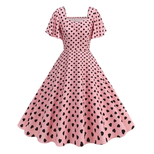 Detail of pink vintage square neck dress with black heart print and ruffle sleeves