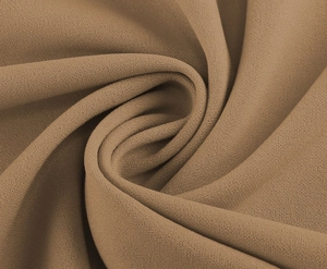 Detail view of the elegant tan crepe fabric showing premium textured grain and soft drape