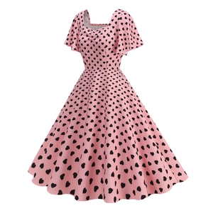 Detailed view of the 1950s retro square neck and black heart print on pink fabric