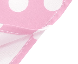 Detailed close-up of sewing craftsmanship on pink polka dot dress with precise white stitching