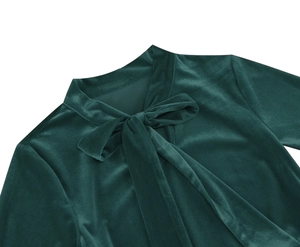 Detail of elegant forest green velvet dress neckline with a pussy-bow tie design