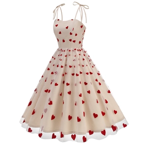 Detail of red heart embroidery on midi dress with tulle overlay and bow straps