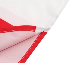 Detailed macro view showing red and white fabric texture and fine stitching on the dress