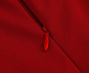 Detail shot of a red vintage dress showing high-quality invisible zipper and fabric texture
