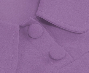 Detail shot of purple dress featuring fabric-covered buttons and textured lapel structure