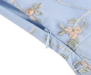 Close-up of light blue mesh dress showing pink floral embroidery and invisible zipper detail