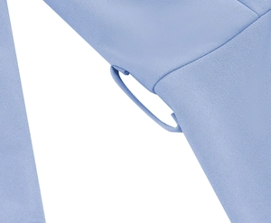 Detailed macro view of the light blue woven fabric texture and stitched belt loop detail