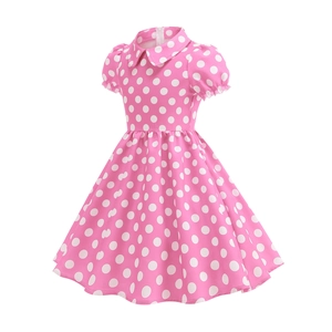 Detailed close-up of pink polka dot cotton dress with retro puff sleeves and doll collar