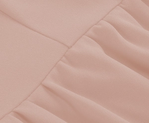 Detailed close-up of lotus pink chiffon fabric with fine stitching and ruffle pleats