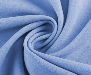 Close-up of blue chiffon fabric texture showing soft draping and elegant ripple effect