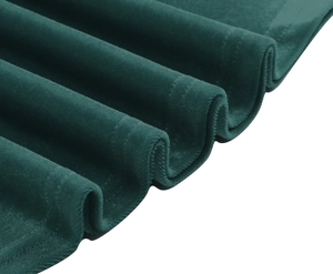 Close-up detail of dark green velvet fabric texture and soft sheen of the elegant dress