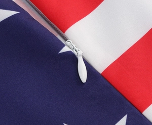 Detail showing the white invisible zipper and woven texture of the flag print dress