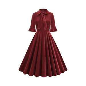 Close-up of velvet wine red dress featuring elegant bow tie collar and ruffle bell sleeves