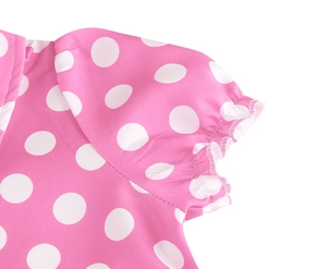 Close-up of pink polka dot cotton dress collar and pleated sleeve tailoring details