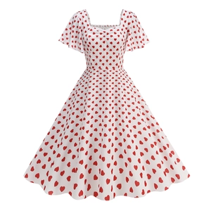 Detail view of red heart print on white fabric with square neckline and ruffled sleeves