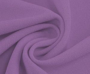 Detailed macro view of purple chiffon fabric with elegant spiral pleats and soft texture