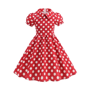Detailed view of red polka dot dress featuring Peter Pan collar and puff sleeves