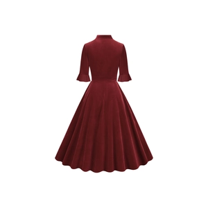 Back view of a vintage dark red velvet dress with ruffled sleeves and an A-line skirt