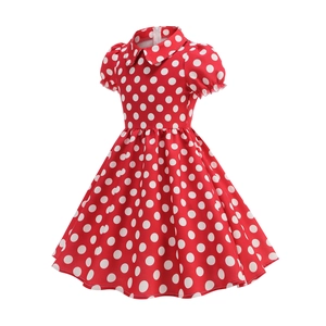 Detail of red and white polka dot girl dress with Peter Pan collar and puff sleeves