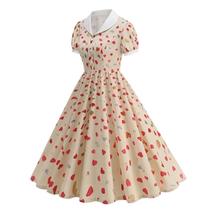 Detailed view of the apricot retro A-line dress featuring heart prints and white lapel collar