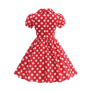 Detailed view of red polka dot dress with bubble sleeves and a retro doll collar