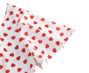 Detail of red heart print on white fabric with flutter sleeve design on midi dress