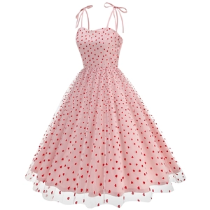 Detail of pink mesh dress featuring heart embroidery and bow tie shoulder straps