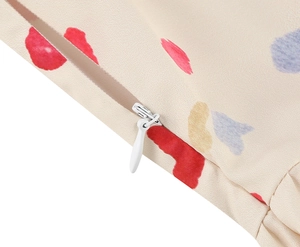 Detail of hidden zipper on vintage dress with colorful abstract heart floral pattern