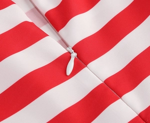 Detailed macro view of the invisible white zipper on a red and white striped dress