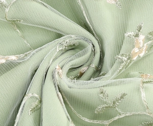 Detail of light green floral embroidery on premium mesh fabric for sleeveless dress