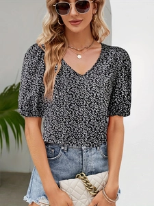 Detail of elegant V-neck floral blouse with bubble sleeves and white petal patterns