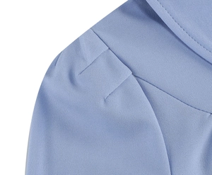 Close-up of puff sleeve pleats and light blue chiffon fabric texture on dress
