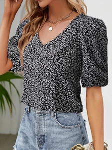 Detail of floral V-neck top with puff sleeves and dainty white flower pattern