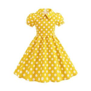 Detailed view of the yellow polka dot dress with Peter Pan collar and puff sleeves