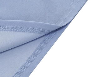Close-up of light blue fabric featuring professional double-needle overlock stitching