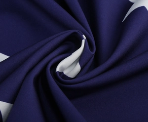 Detailed view of dark blue woven fabric with white star patterns and smooth texture