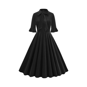 Detail of vintage black dress featuring bow neckline, bell sleeves and pleated A-line hem