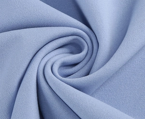 Detailed close-up of soft lilac blue knitted fabric texture with elegant draped folds