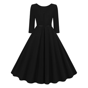 Detail view of the vintage black V-neck dress featuring a cinched waist and A-line pleated skirt
