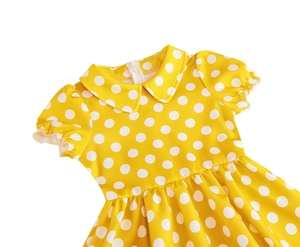 Detail of yellow cotton dress with white polka dots, Peter Pan collar and puff sleeves