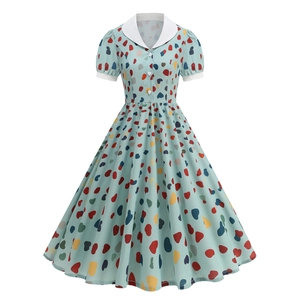 Detail of light blue vintage dress with colorful heart print and white Peter Pan collar