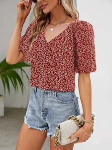Detail of red floral V-neck blouse featuring puff sleeves and breathable summer fabric