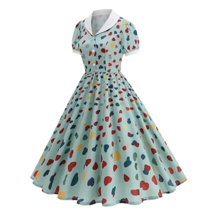 Detail of vintage mint green dress featuring colorful heart prints and white collar
