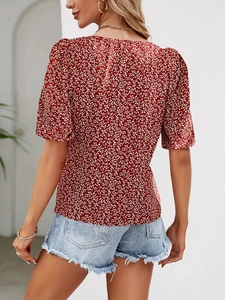 Back view of a red floral short sleeve blouse paired with light blue denim shorts