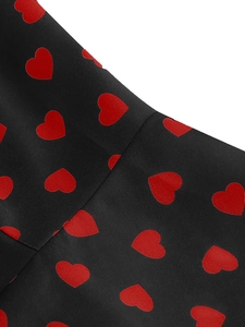 Macro detail of high-quality woven fabric featuring red heart print on black dress