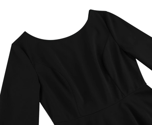 Detail of black dress featuring princess seams and high-quality matte fabric texture