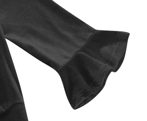 Detailed macro view of the elegant black ruffle cuffs and smooth fabric of the dress