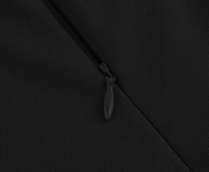 Close-up of a black invisible zipper on premium textured fabric for a vintage dress
