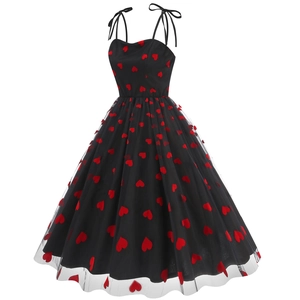 Detail of black A-line strap dress featuring red heart embroidery and mesh overlay